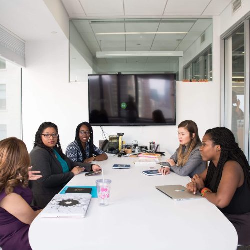 A diverse group of women collaborating during a board meeting
